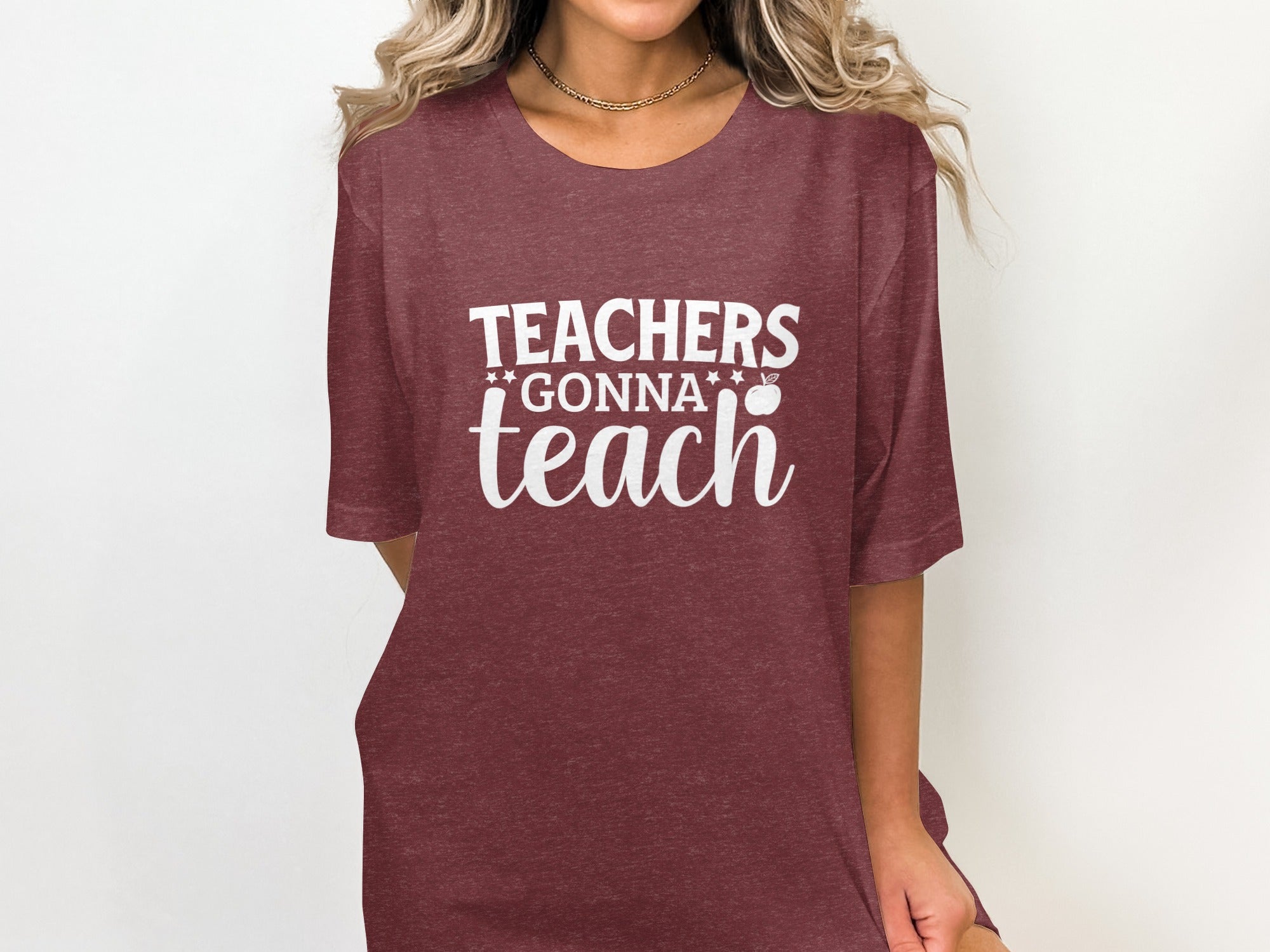 Maroon t-shirt with white text reading "TEACHERS GONNA teach" and an apple graphic.
