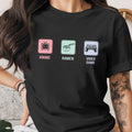 Black t-shirt with three squares displaying anime, ramen, and video game icons.