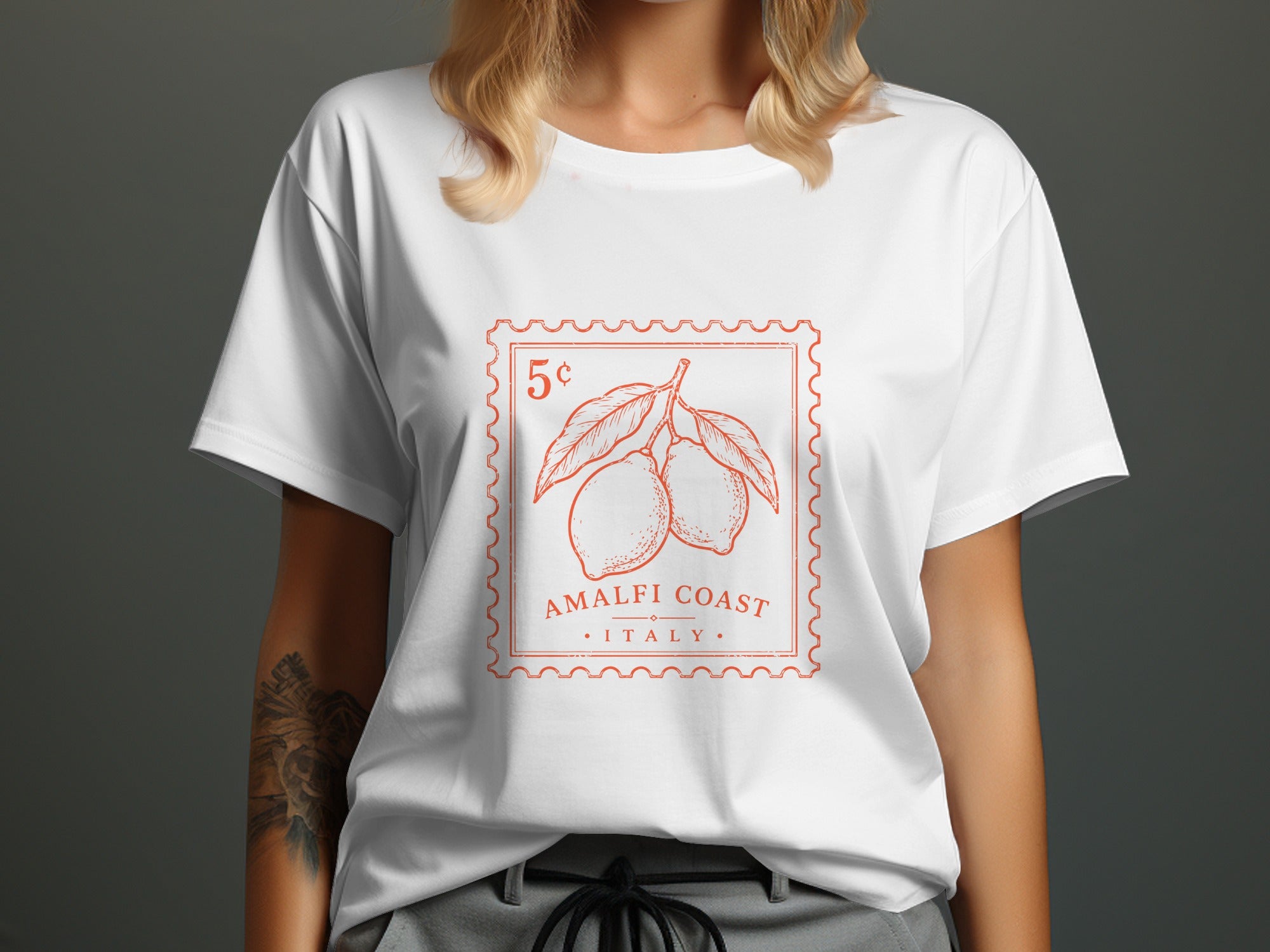 White t-shirt with orange stamp graphic of lemons, "AMALFI COAST ITALY".