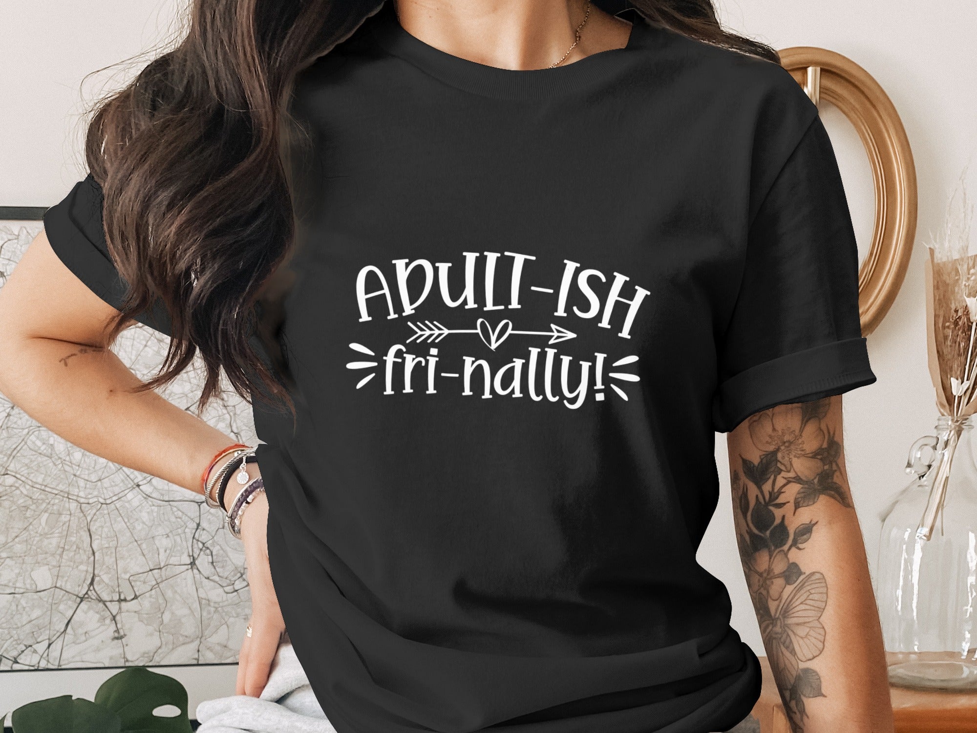 Black t-shirt with white text "ADULT-ISH fri-nally!".