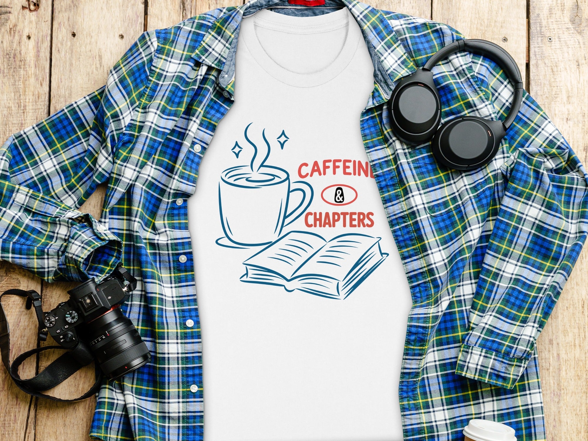 White t-shirt with "Caffeine & Chapters" graphic, blue plaid shirt, headphones, and camera.