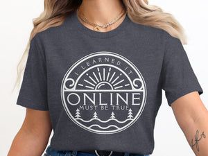 Dark grey t-shirt with white circle graphic "I LEARNED IT ONLINE MUST BE TRUE".