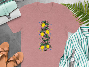 Pink t-shirt with a central lemon branch design and colorful stars.