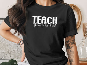 Black t-shirt with white text "TEACH them to be kind".