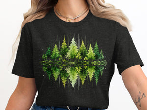 Watercolor forest scene with trees reflected in water on a dark t-shirt.