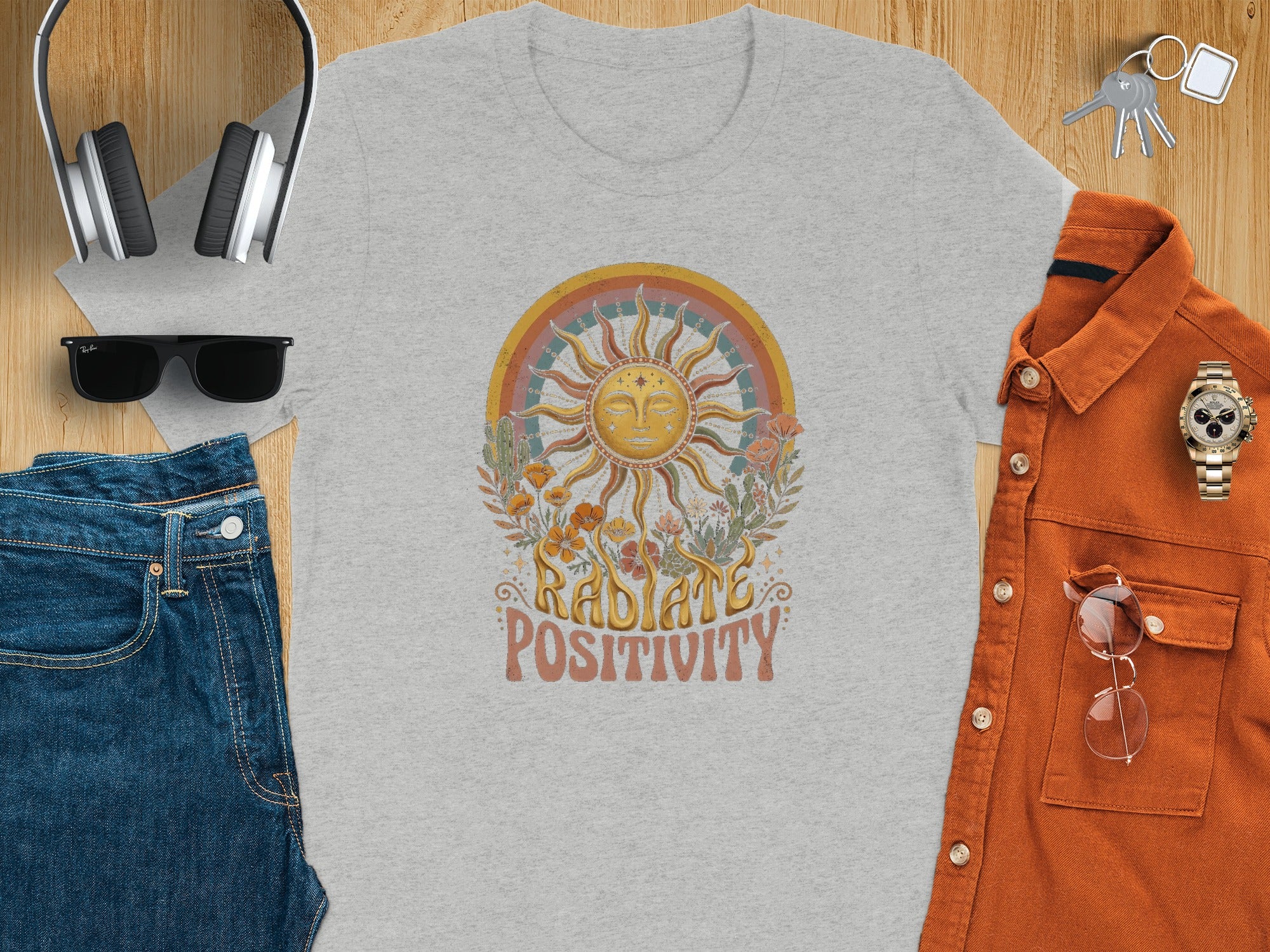 Gray t-shirt with a sun design and text "Radiate Positivity".