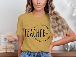 Yellow t-shirt with black text "TEACHER" inside a circle with "LOVE INSPIRE MOTIVATE EDUCATE".
