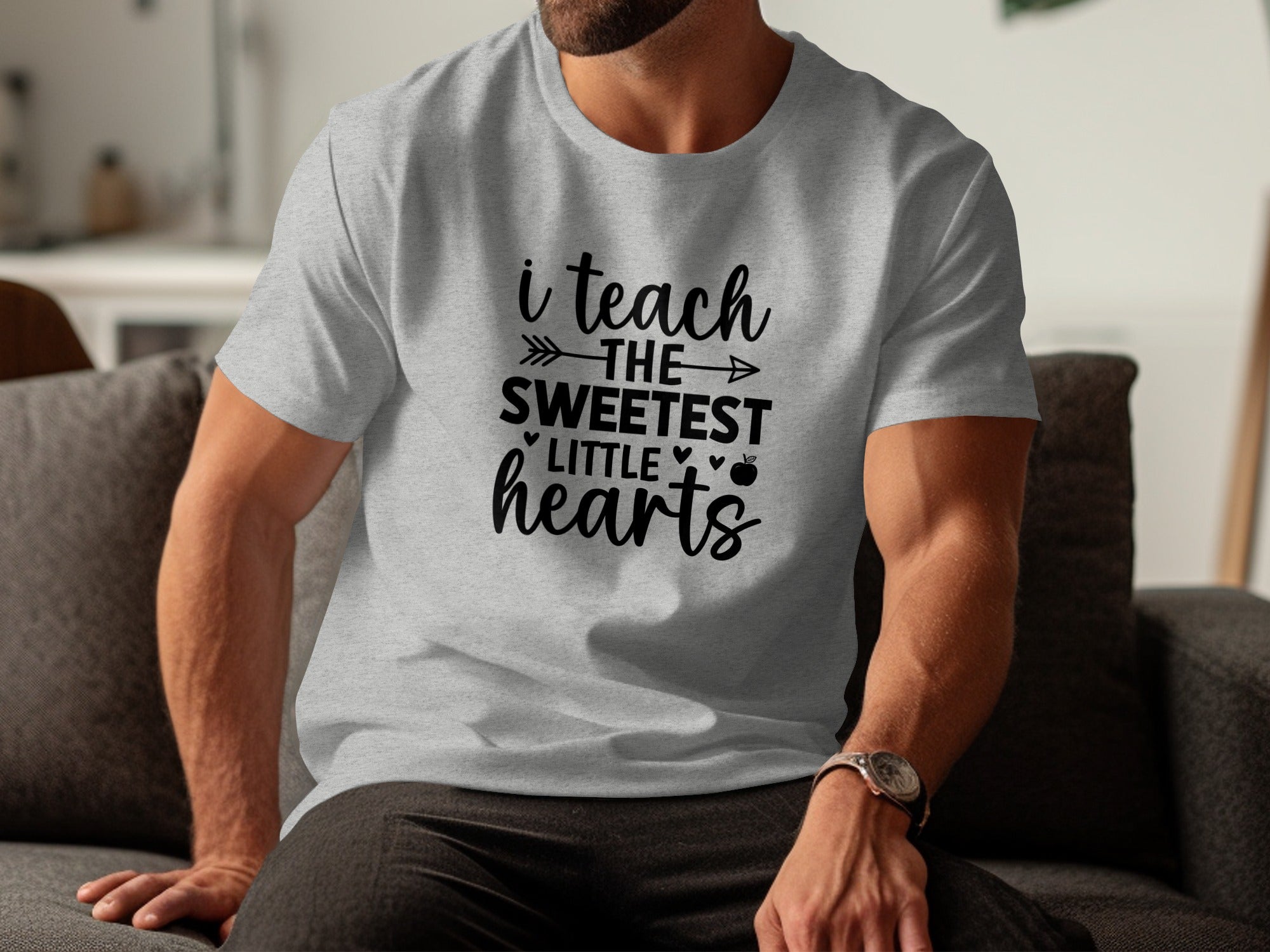 Grey t-shirt with black text: "i teach THE SWEETEST LITTLE hearts"