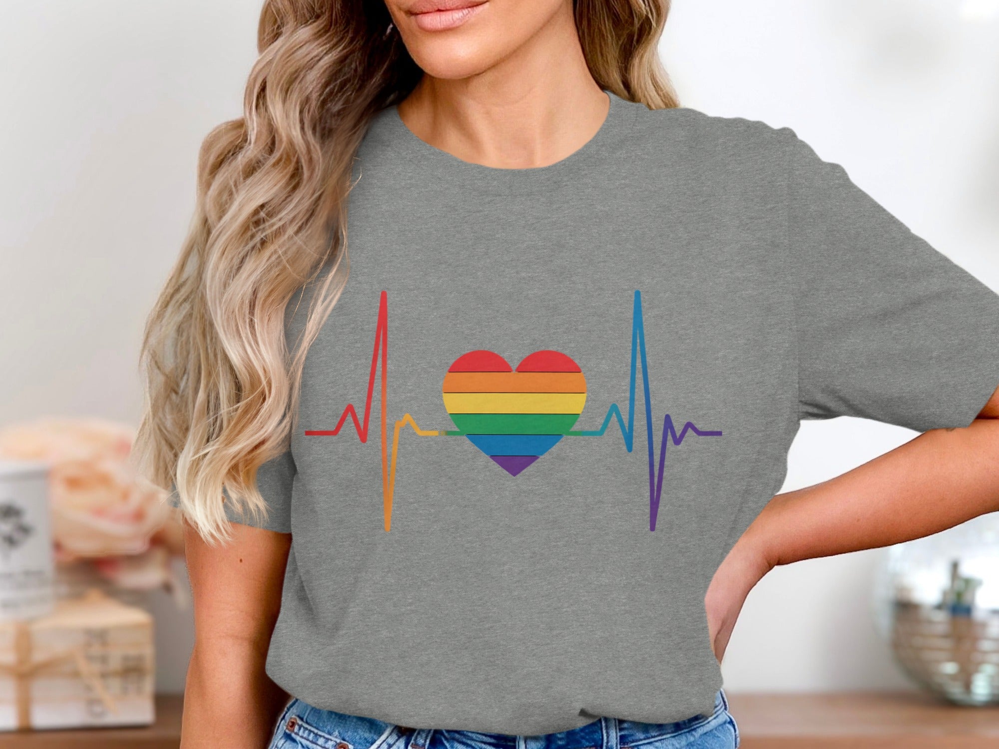 Grey t-shirt with rainbow heartbeat and heart graphic.