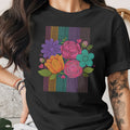 Black t-shirt with a colorful floral bouquet design against a striped background.