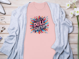 Pink t-shirt with "Never Let Anyone Dull Your Sparkle" graphic.