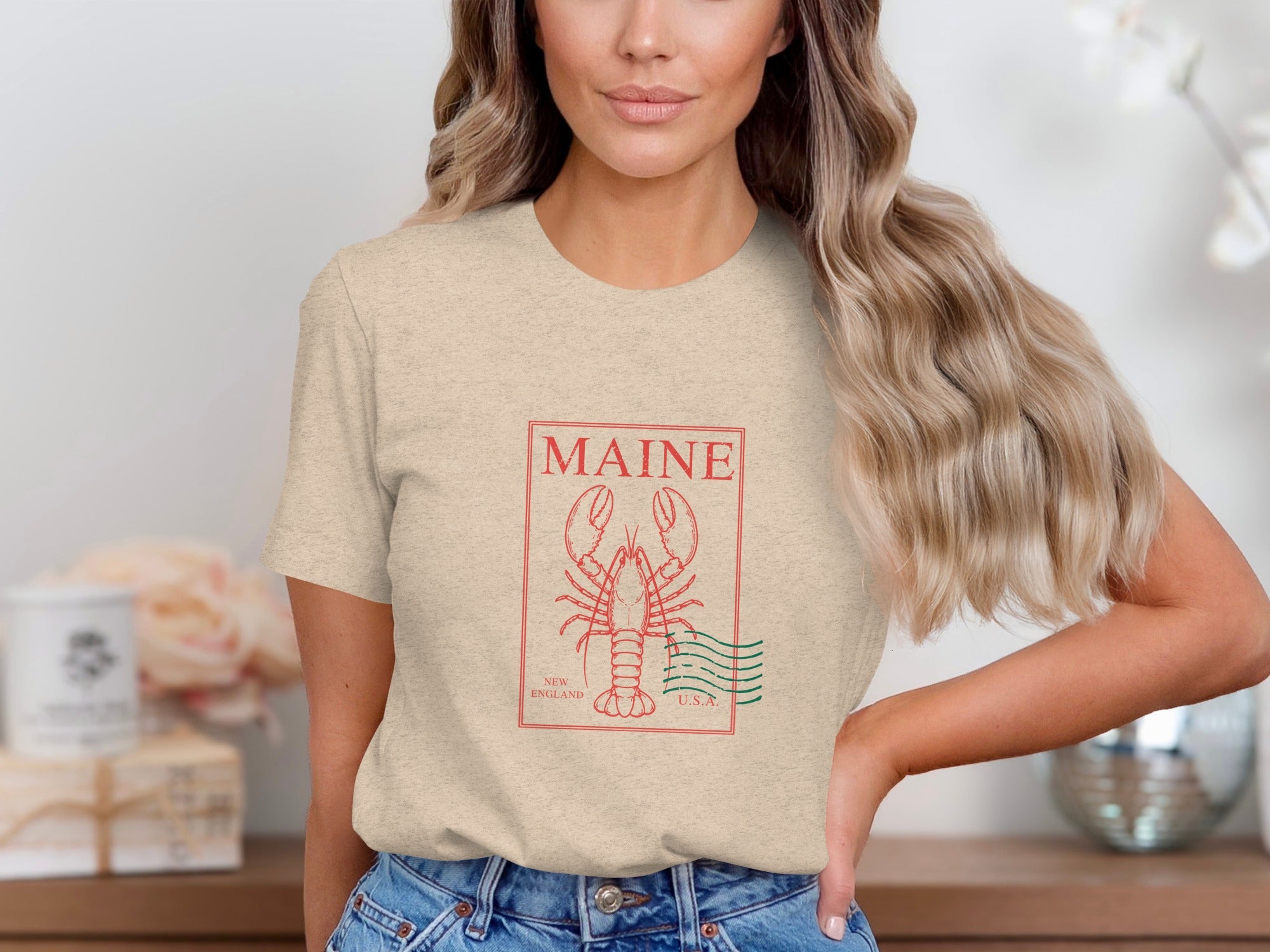 Light tan t-shirt with red Maine lobster graphic and "New England U.S.A." text.