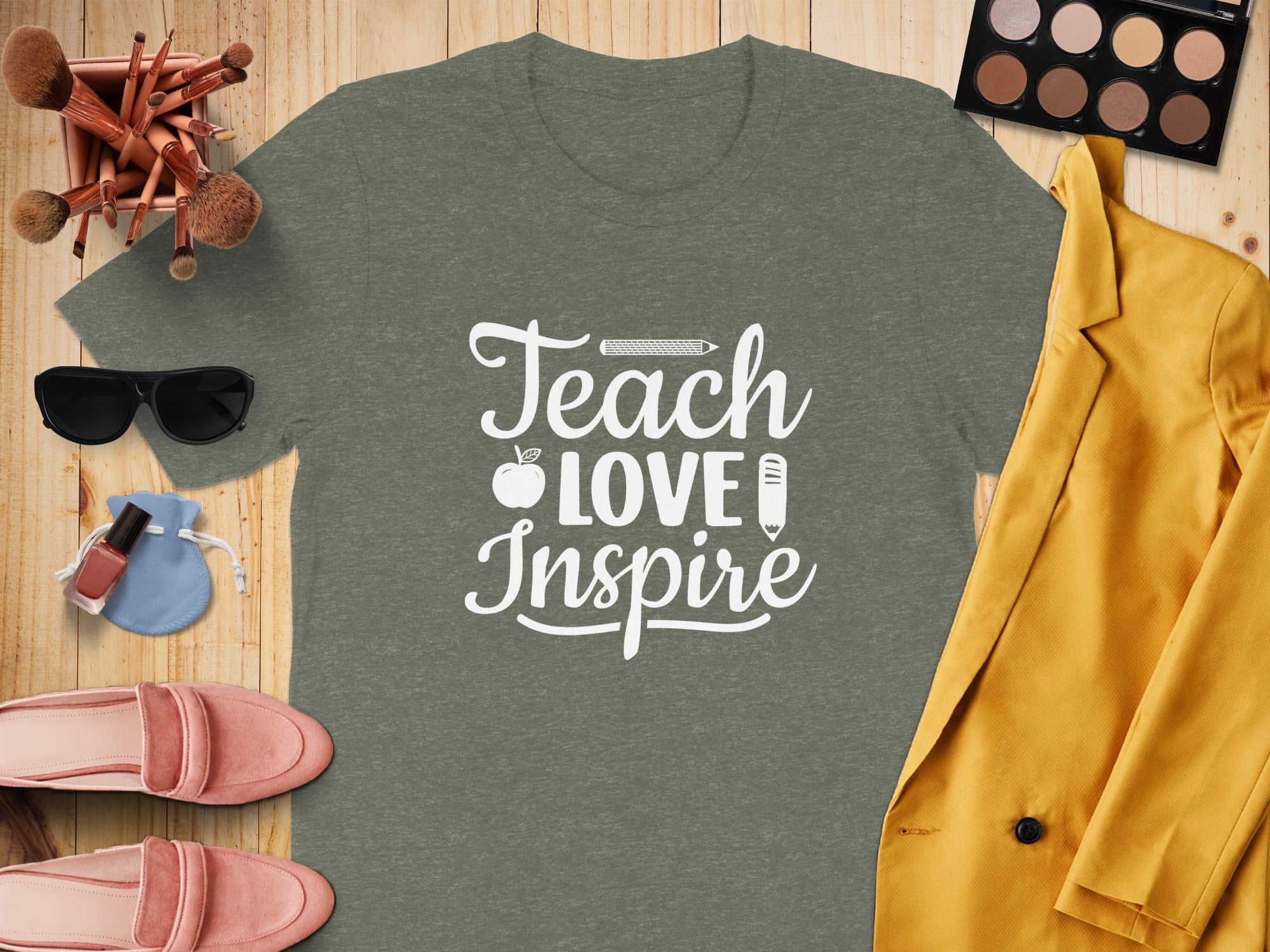 Green t-shirt with white text "Teach Love Inspire" surrounded by accessories.