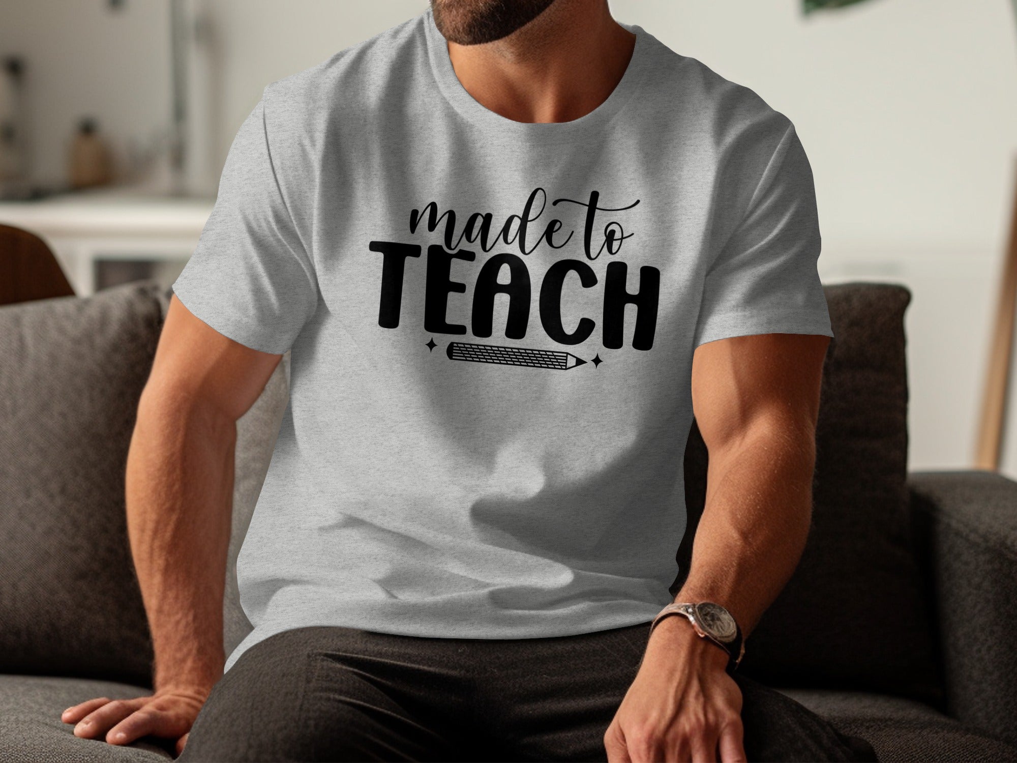 Grey t-shirt with black text "made to TEACH" and a pencil graphic.