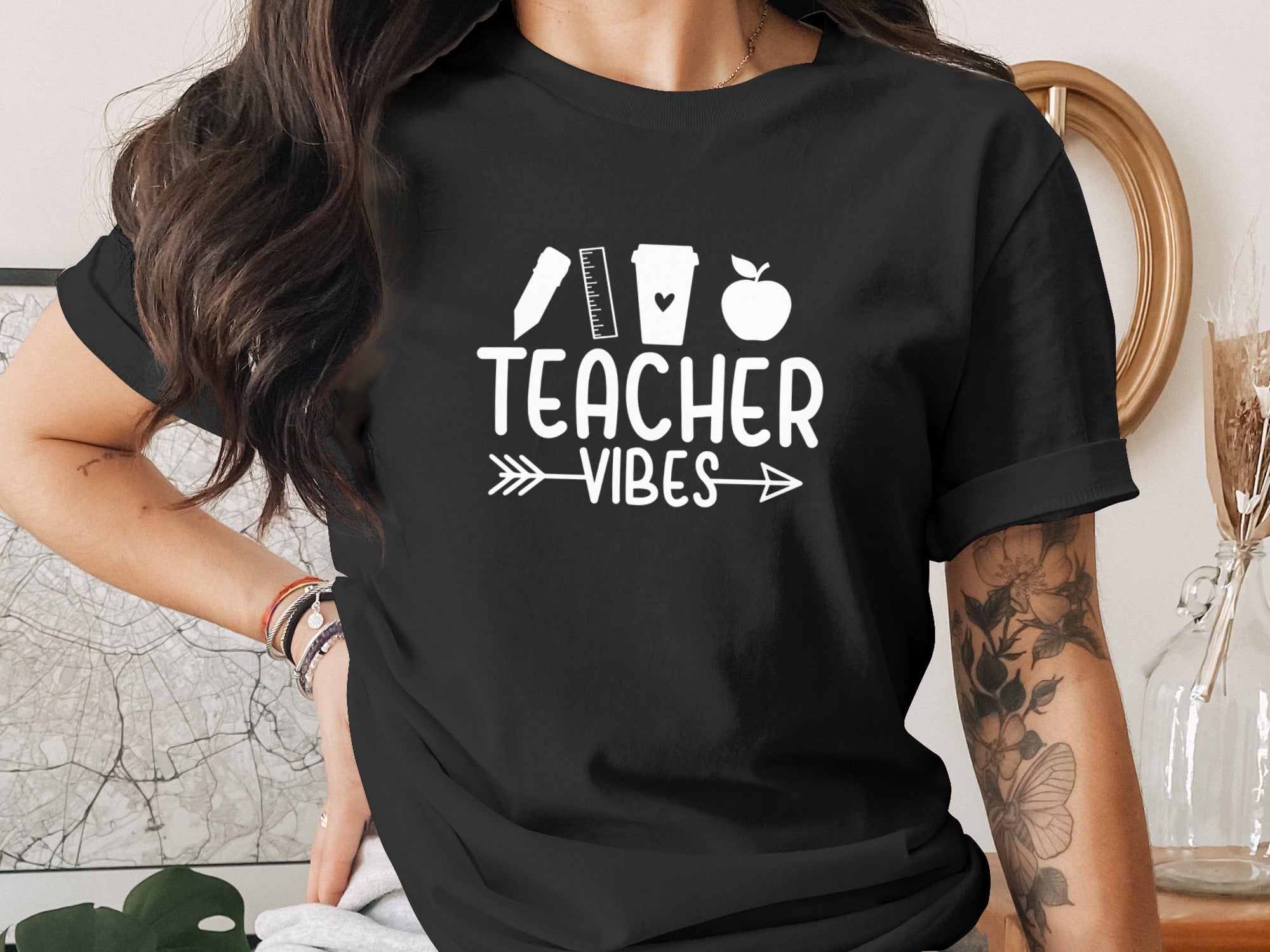 Black t-shirt with "Teacher Vibes" text and teacher-themed icons.