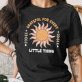 Black t-shirt with "Grateful for Every Little Thing" text and sun graphic.