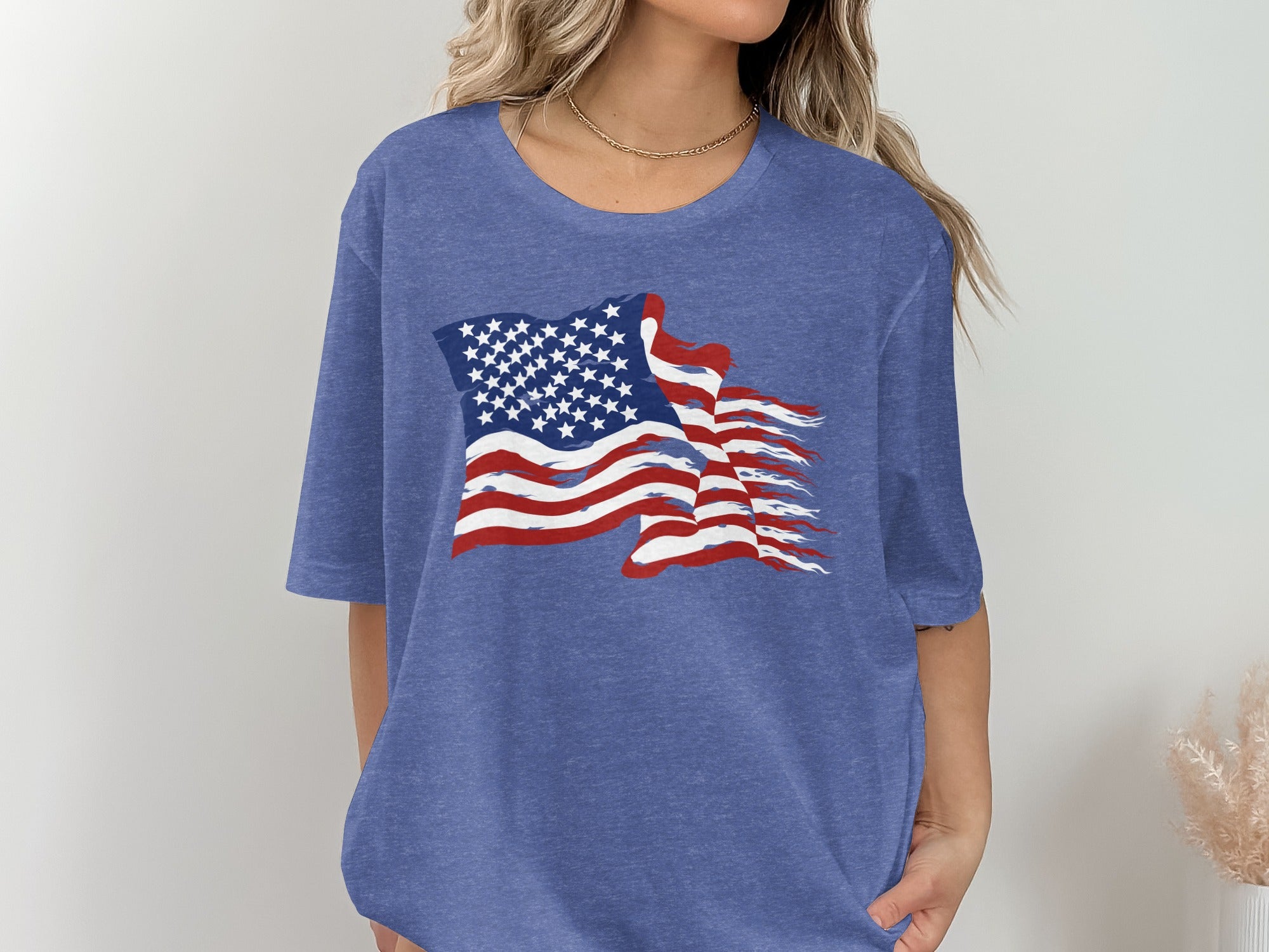 Blue t-shirt with distressed American flag graphic on front.
