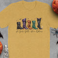 Yellow t-shirt with illustrated witch boots and text "A Girl's Gotta Have Options".
