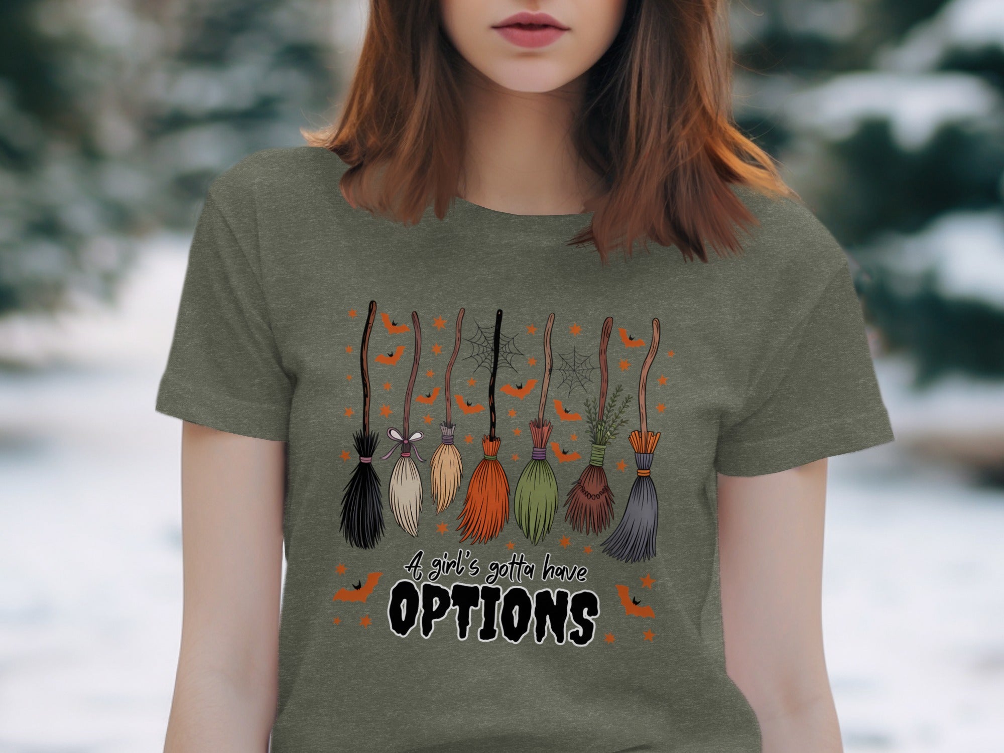 T-shirt with illustration of seven brooms and text "A girl's gotta have OPTIONS."