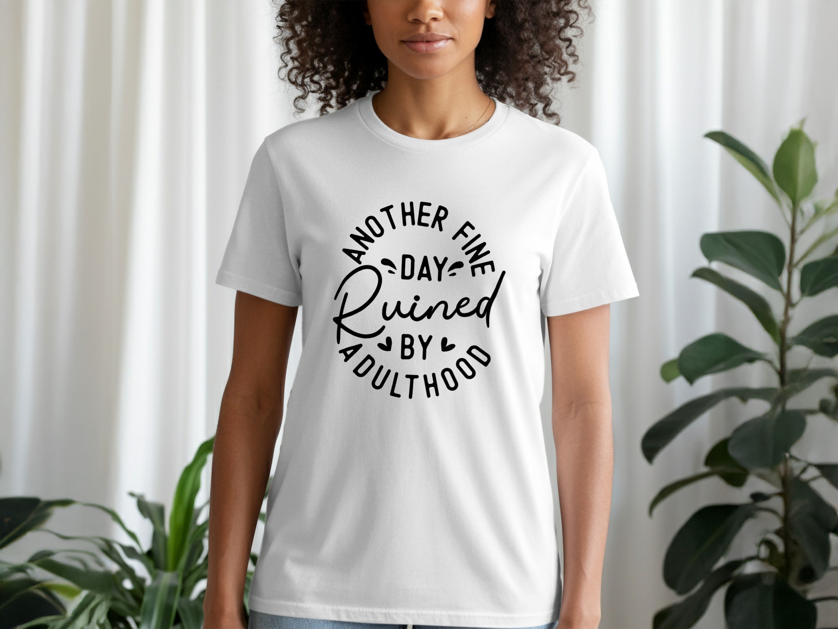 White t-shirt with black text "Another Fine Day Ruined by Adulthood"