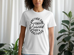 White t-shirt with black text "Another Fine Day Ruined by Adulthood"