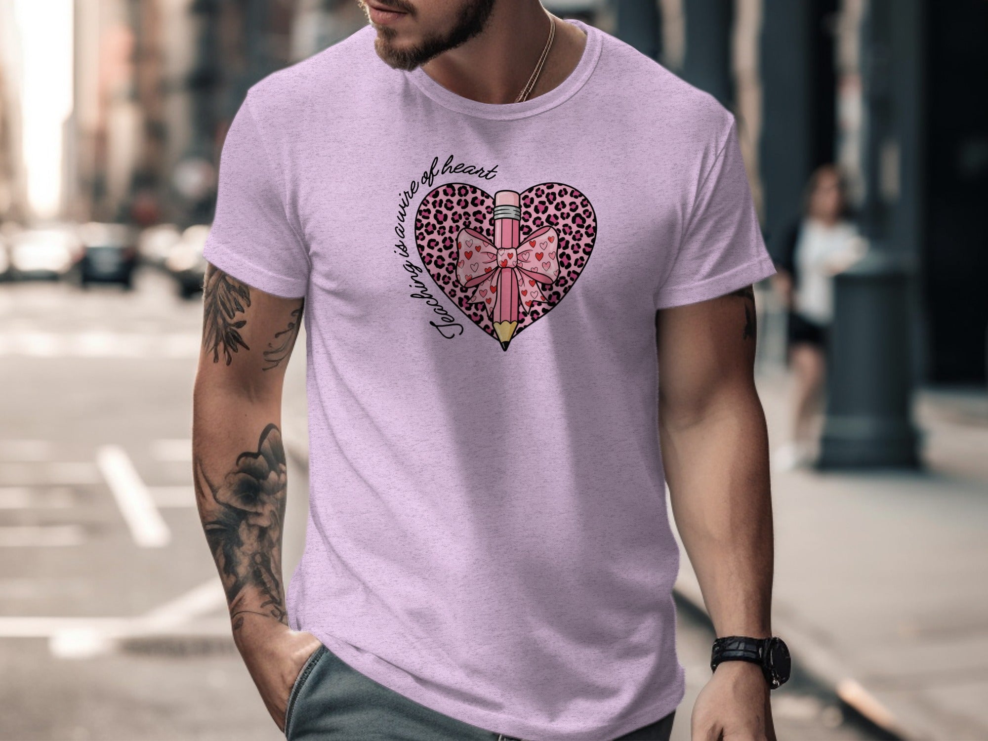 Pink t-shirt with heart graphic featuring a leopard print, pencil, and bow.