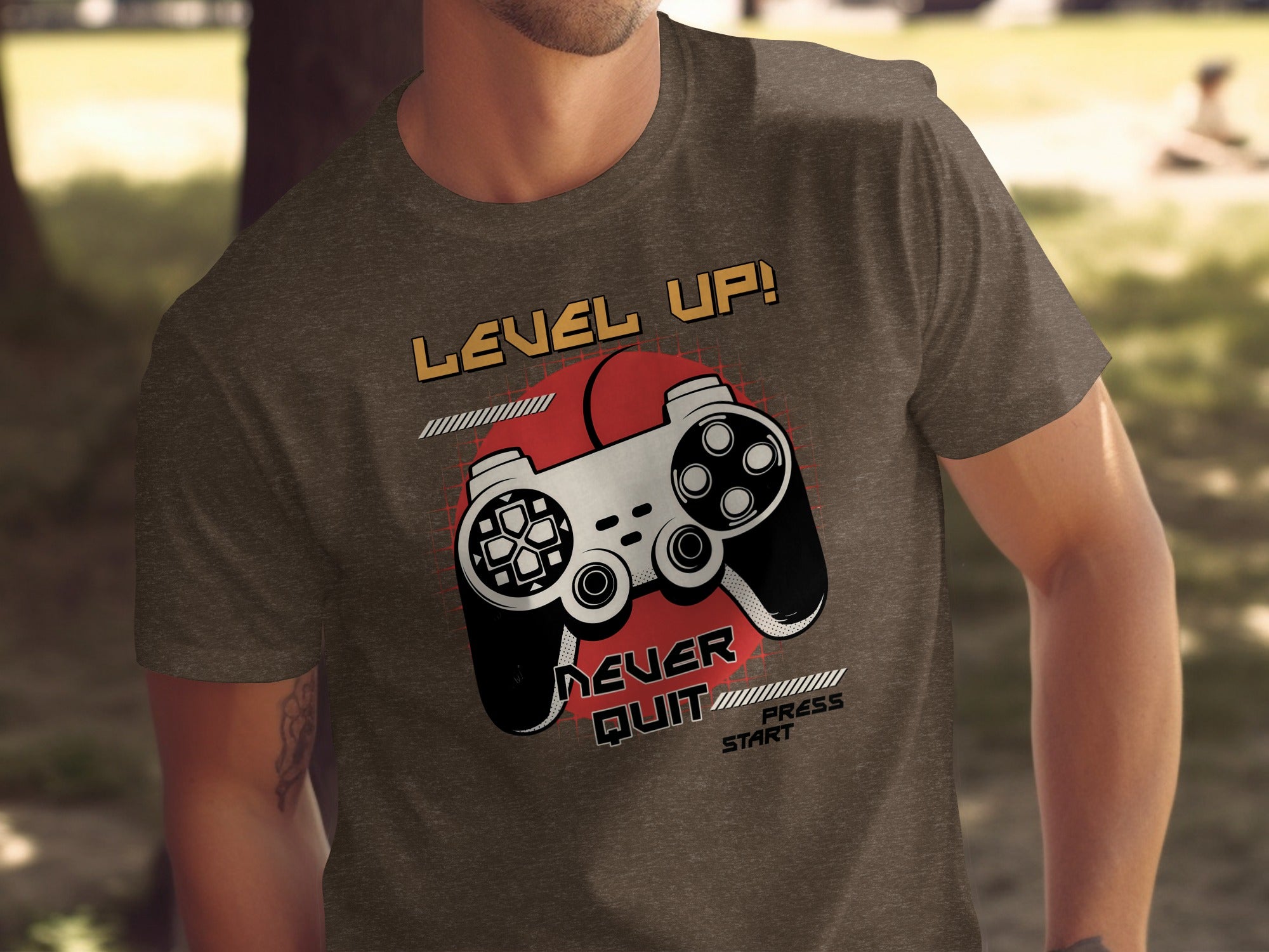Brown t-shirt with "Level Up!" and video game controller graphic.