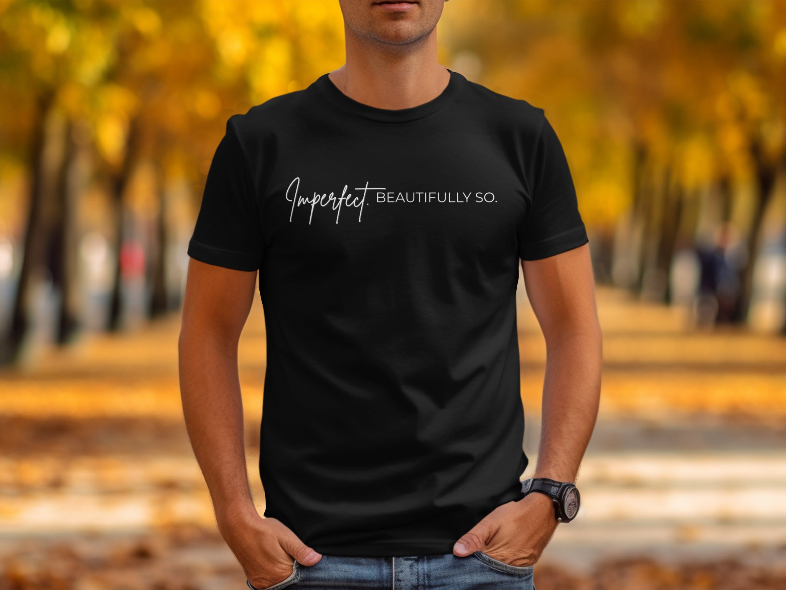 Black t-shirt on a person with "Imperfect. BEAUTIFULLY SO." text.