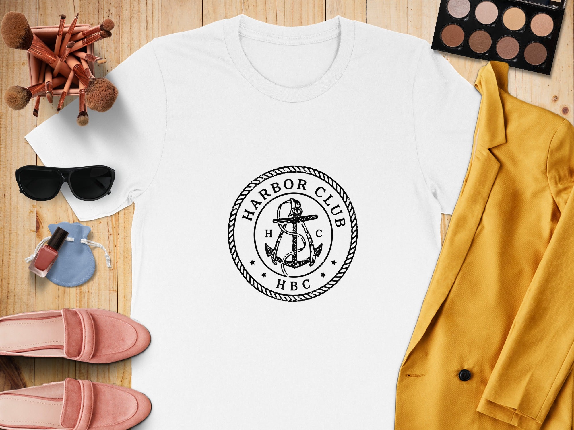 White t-shirt with "Harbor Club HBC" anchor logo, gold blazer, pink loafers, sunglasses, and makeup.
