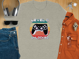 T-shirt with "Level 11 Unlocked" text and retro video game controller graphic.