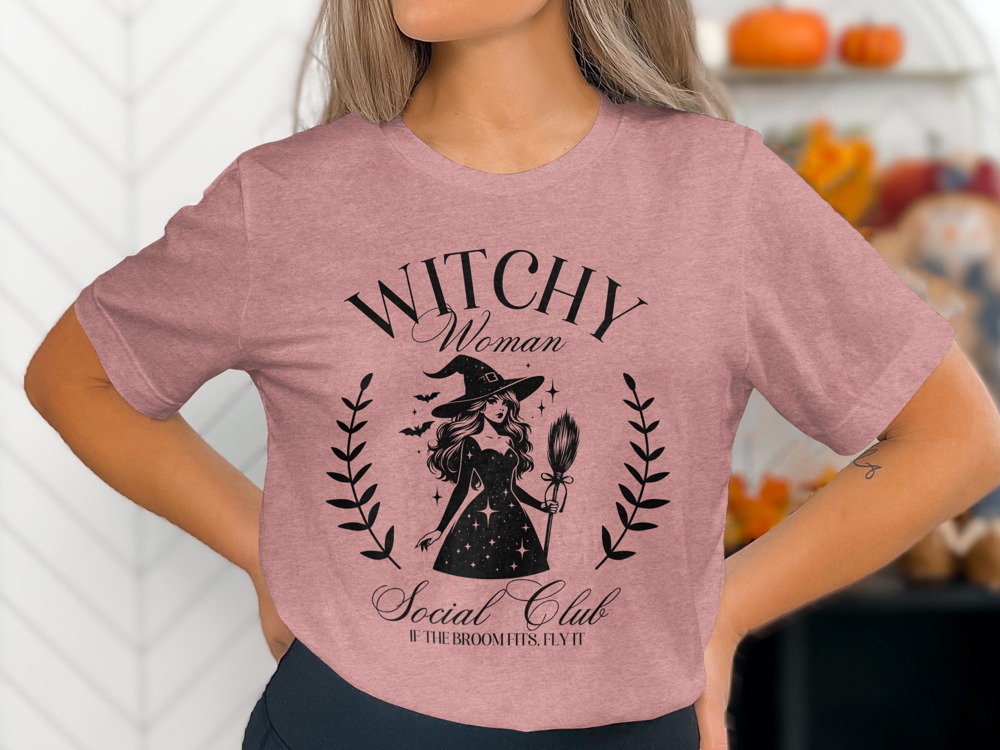 "Witchy Woman Social Club" text on a dusty rose t-shirt with witch graphic.