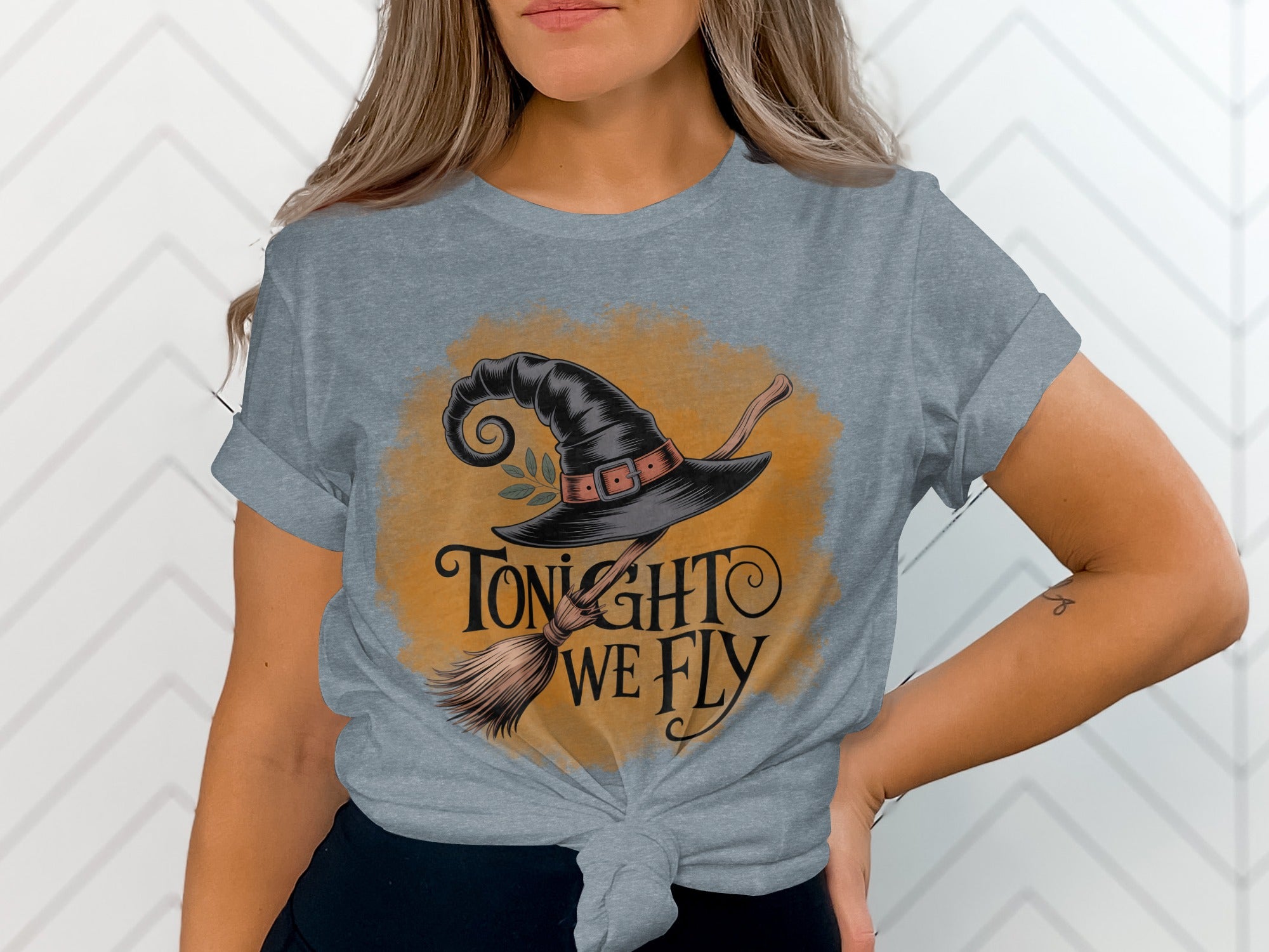 Witch hat and broom graphic with text "Tonight We Fly" on a gray t-shirt.