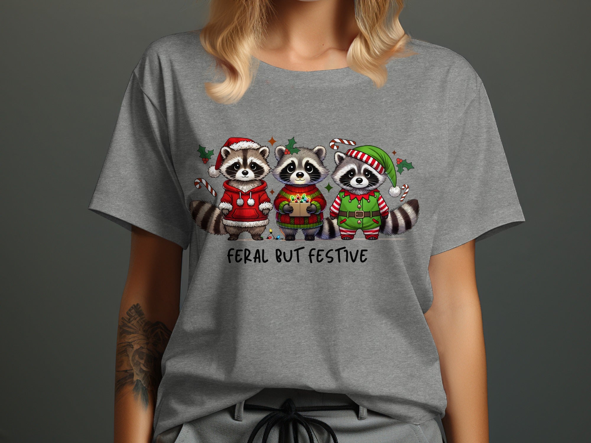 Three raccoons in festive holiday attire with the text "Feral But Festive".