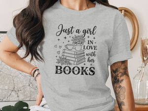 Grey t-shirt with black text and floral design: "Just a girl in love with her books."