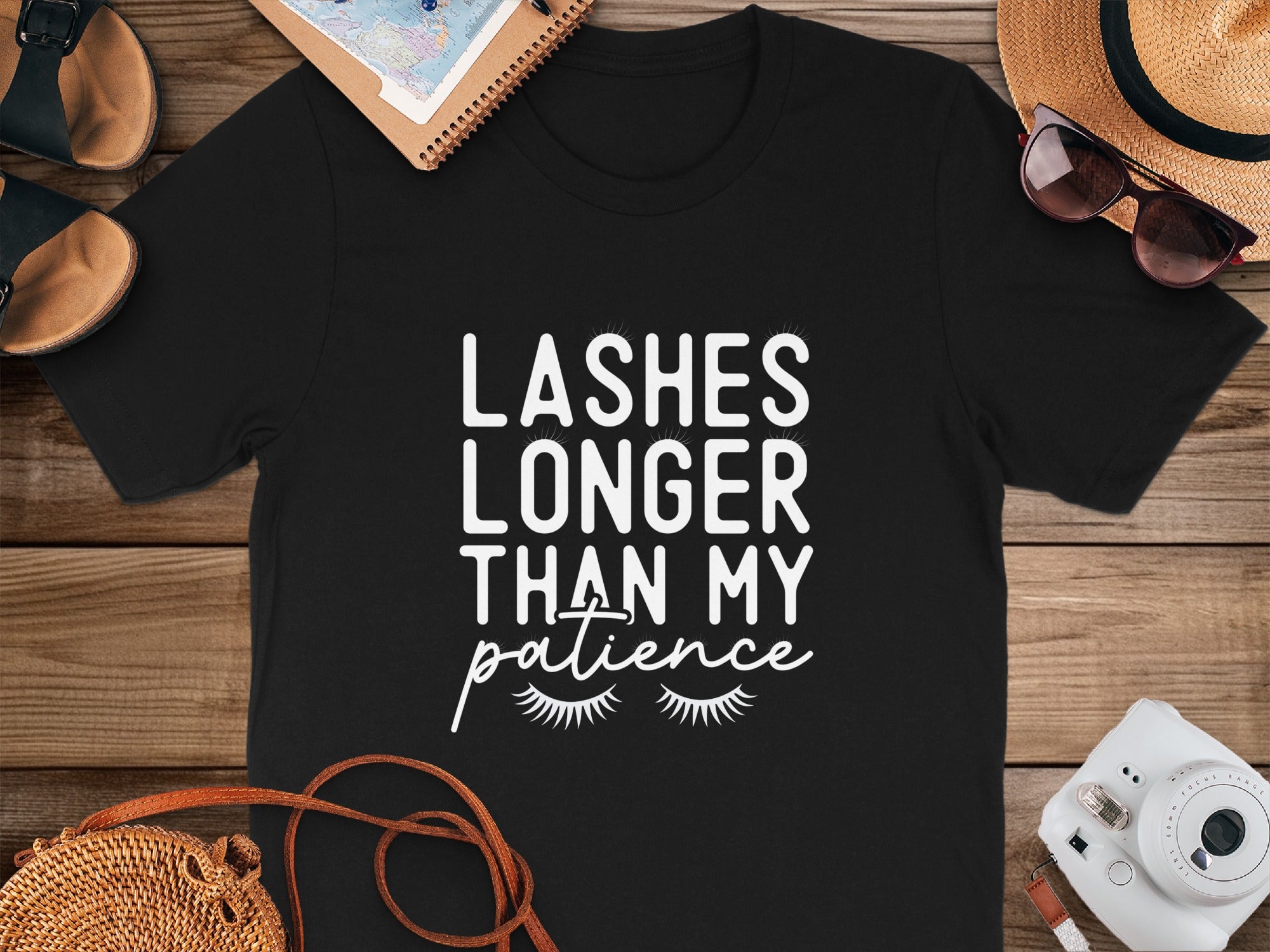 Black t-shirt with white text reading "Lashes longer than my patience".