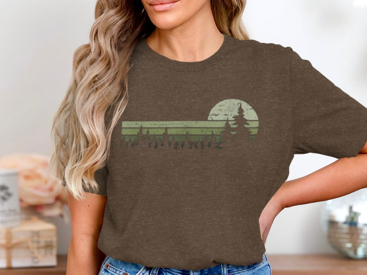 Brown t-shirt with a retro sunset and pine trees graphic design.