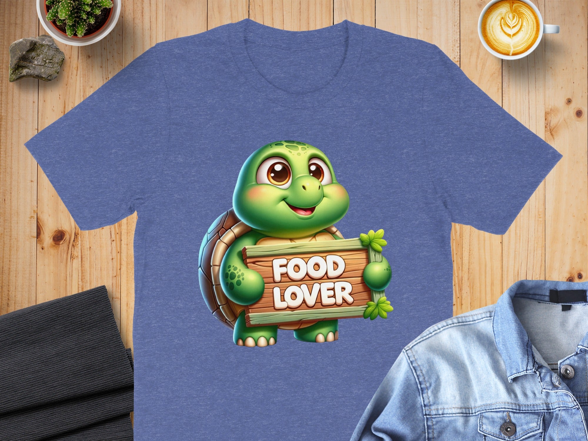 Cartoon turtle holding sign that says "FOOD LOVER" on a blue t-shirt.