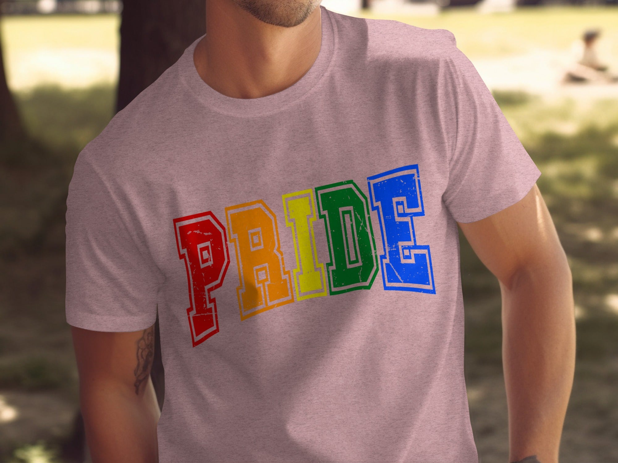 Pink t-shirt with rainbow-colored "PRIDE" text in distressed lettering.