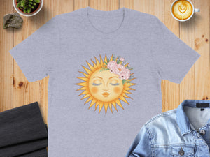 Grey t-shirt with a sun graphic featuring closed eyes and floral crown.