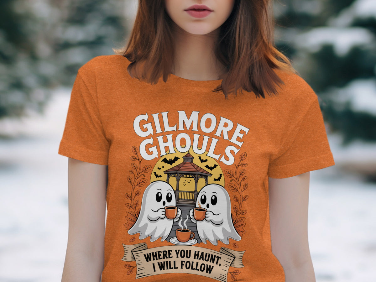 Orange t-shirt with "Gilmore Ghouls" and two ghosts drinking coffee.
