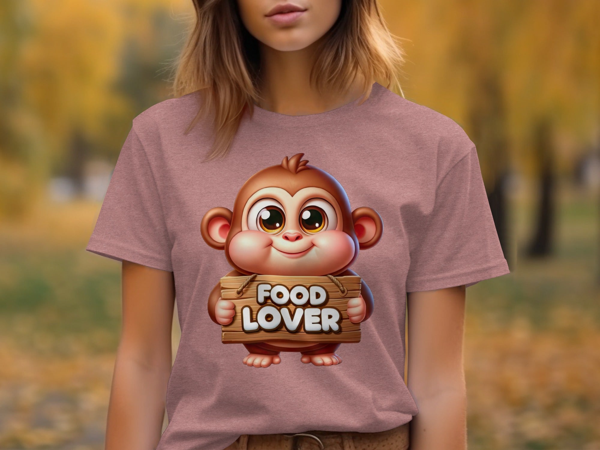 Cartoon monkey holding a "FOOD LOVER" sign on a pink t-shirt.