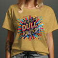 Yellow t-shirt with "Never Let Anyone Dull Your Sparkle" graphic in bold, colorful letters.