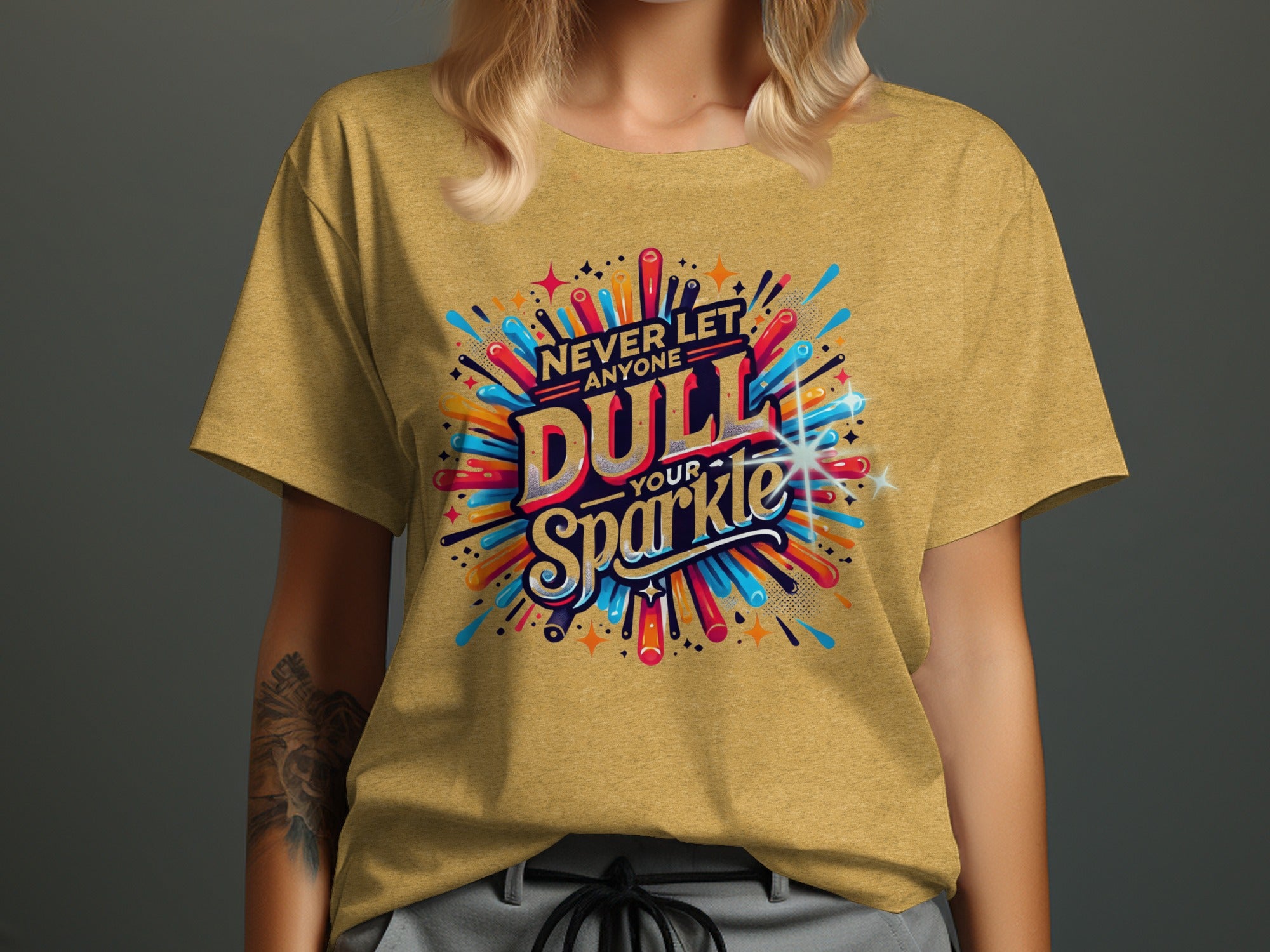 Yellow t-shirt with "Never Let Anyone Dull Your Sparkle" graphic in bold, colorful letters.