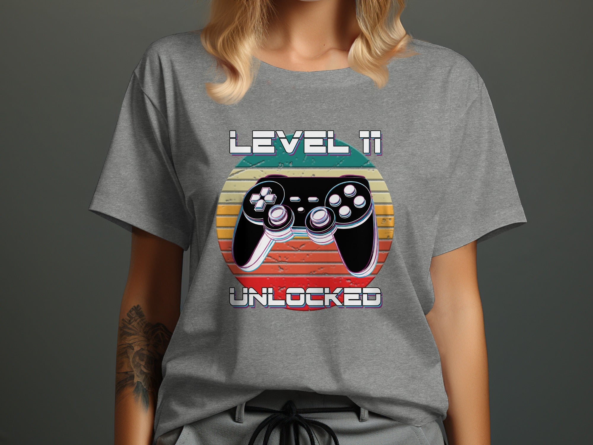 Grey t-shirt with "LEVEL 11 UNLOCKED" text and a video game controller.