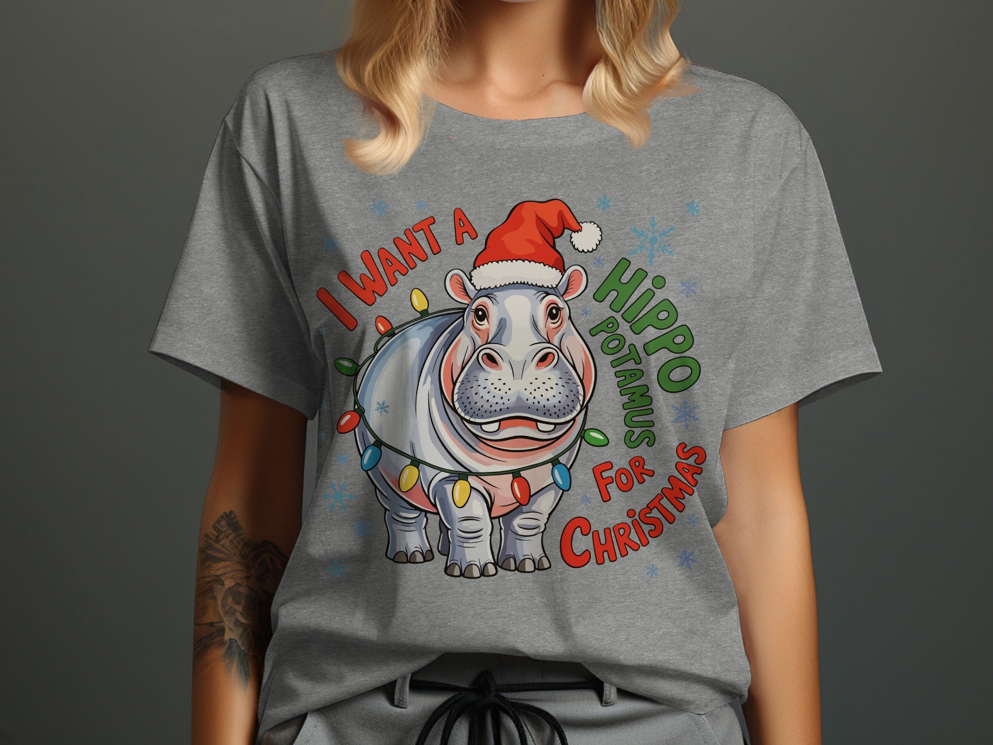 Hippo wearing Santa hat and Christmas lights, text says "I Want a Hippopotamus for Christmas."