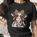 Black t-shirt with a cow wearing leopard print bow, sunglasses, and diamond necklace, blowing bubblegum.