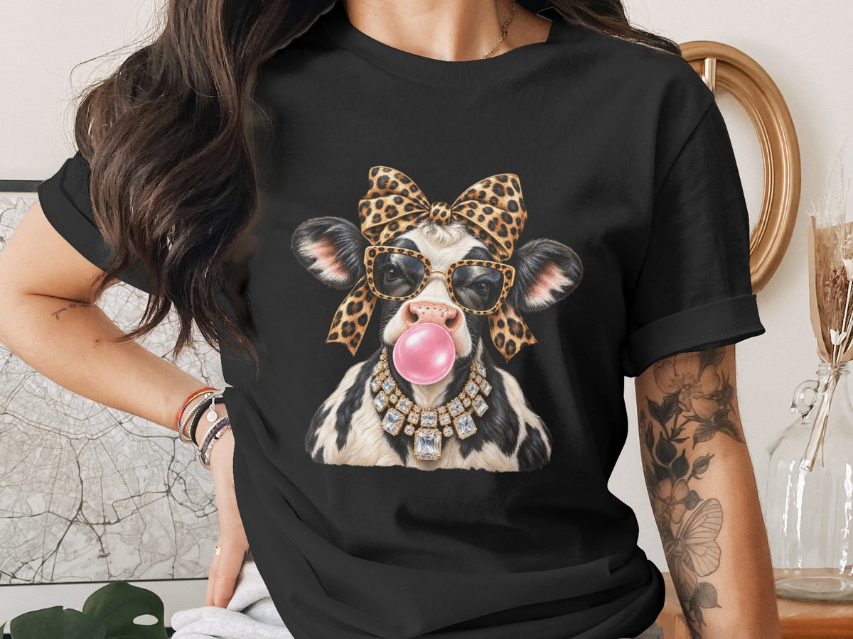 Black t-shirt with a cow wearing leopard print bow, sunglasses, and diamond necklace, blowing bubblegum.