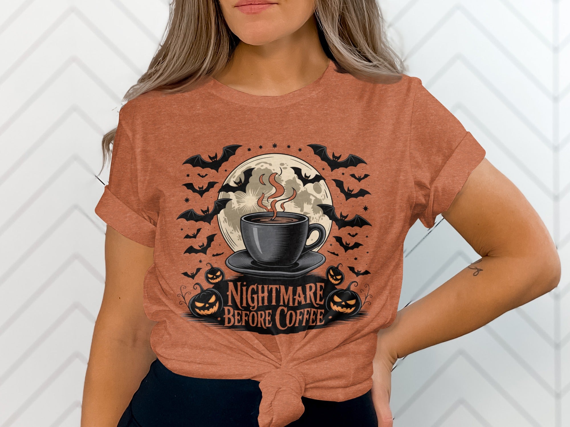 Halloween t-shirt graphic with "Nightmare Before Coffee" text, a coffee cup, bats, moon, and pumpkins.