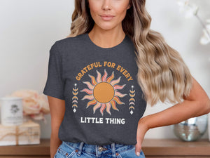 Graphic tee with sun design and text reading "GRATEFUL FOR EVERY LITTLE THING".