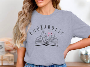 Grey t-shirt with "BOOKAHOLIC" text and an open book with pink flowers design.